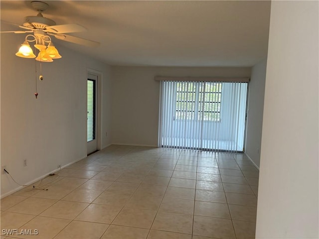 677 12th Ave S Unit 677, Naples, FL 34102 - spare room featuring light tile patterned flooring, baseboards, and ceiling fan