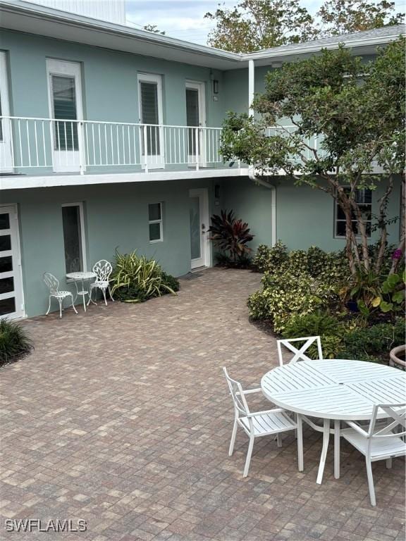 677 12th Ave S Unit 677, Naples, FL 34102 - back of property with a patio, outdoor dining space, and stucco siding