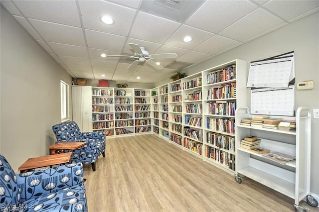 677 12th Ave S Unit 677, Naples, FL 34102 - living area featuring wall of books, wood finished floors, and a drop ceiling