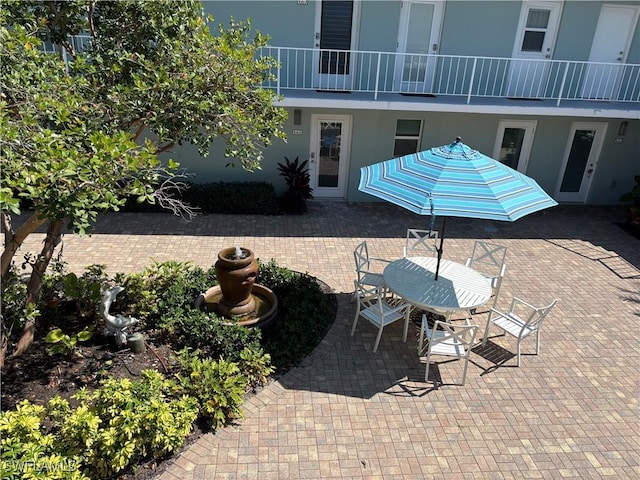 677 12th Ave S Unit 677, Naples, FL 34102 - view of patio featuring a balcony and outdoor dining space