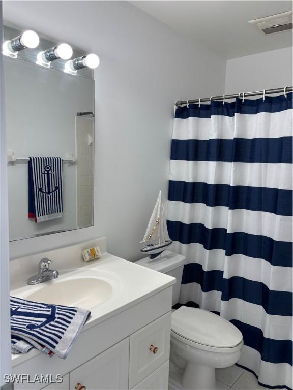 677 12th Ave S Unit 677, Naples, FL 34102 - bathroom featuring toilet, visible vents, tile patterned flooring, a shower with shower curtain, and vanity