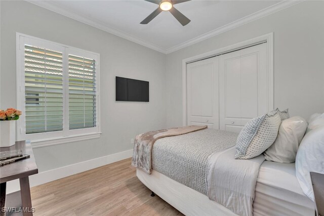 339 Saddlebrook Ln SE, Naples, FL 34110 - bedroom with ornamental molding, wood finished floors, baseboards, a closet, and a ceiling fan
