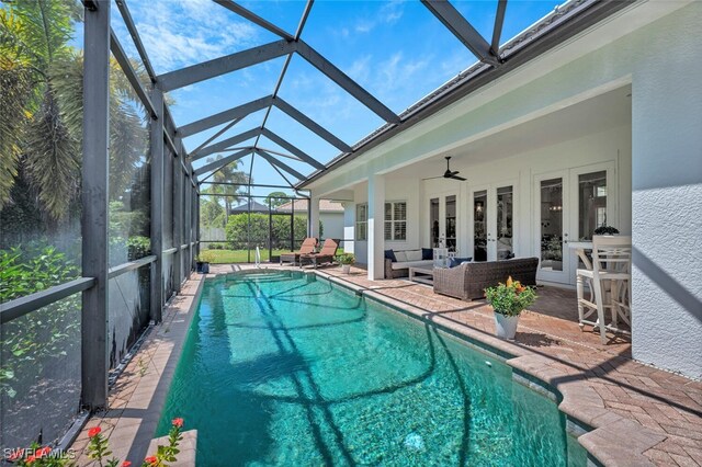 339 Saddlebrook Ln SE, Naples, FL 34110 - swimming pool with french doors, a patio area, outdoor lounge area, a ceiling fan, and a lanai