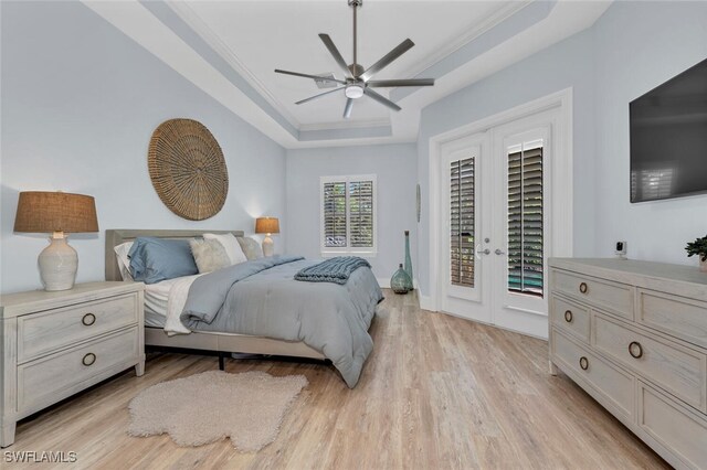 339 Saddlebrook Ln SE, Naples, FL 34110 - bedroom featuring a raised ceiling, access to outside, french doors, light wood-type flooring, and crown molding