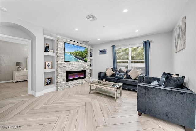 living area with built in shelves, a large fireplace, baseboards, visible vents, and recessed lighting