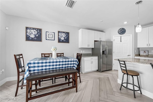 dining area with baseboards and visible vents