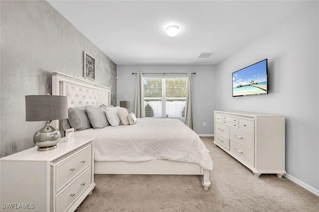 bedroom with baseboards, light colored carpet, and visible vents