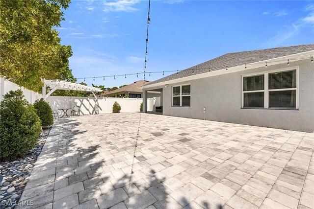 view of patio with a fenced backyard and a pergola