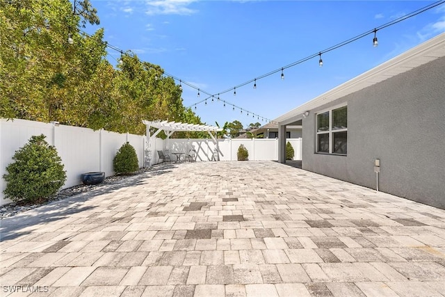 view of patio / terrace featuring a fenced backyard and a pergola