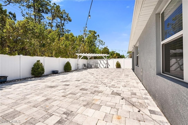 view of patio / terrace with a fenced backyard and a pergola