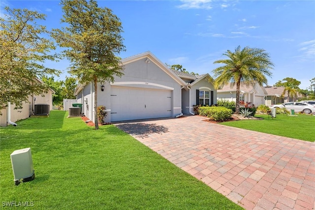 ranch-style house with a front yard, decorative driveway, stucco siding, and an attached garage