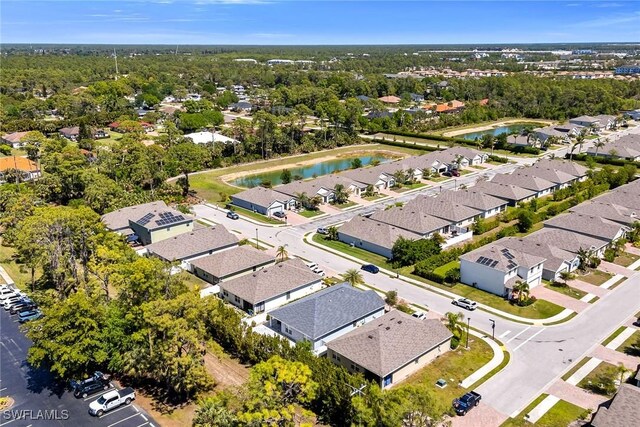 drone / aerial view featuring a residential view and a water view