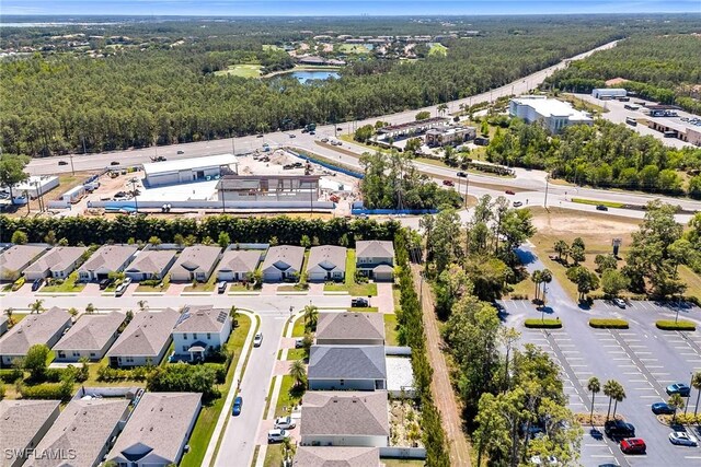 bird's eye view with a water view, a wooded view, and a residential view