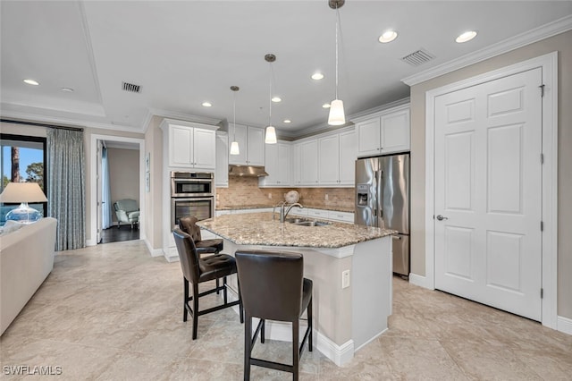 kitchen with a sink, visible vents, ornamental molding, and appliances with stainless steel finishes