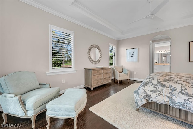 bedroom featuring baseboards, arched walkways, ornamental molding, and dark wood-type flooring