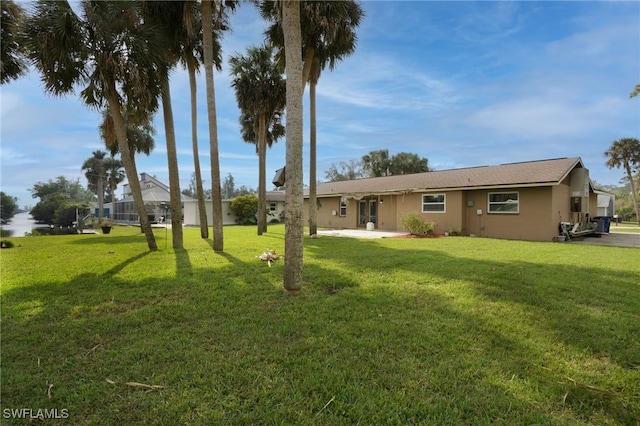 2324 Westwood Rd, North Fort Myers, FL 33917 - view of front of house featuring a front yard, a patio area, and stucco siding