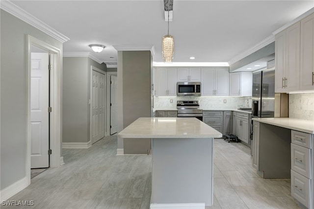 2324 Westwood Rd, North Fort Myers, FL 33917 - kitchen with gray cabinets, a center island, crown molding, backsplash, and stainless steel appliances