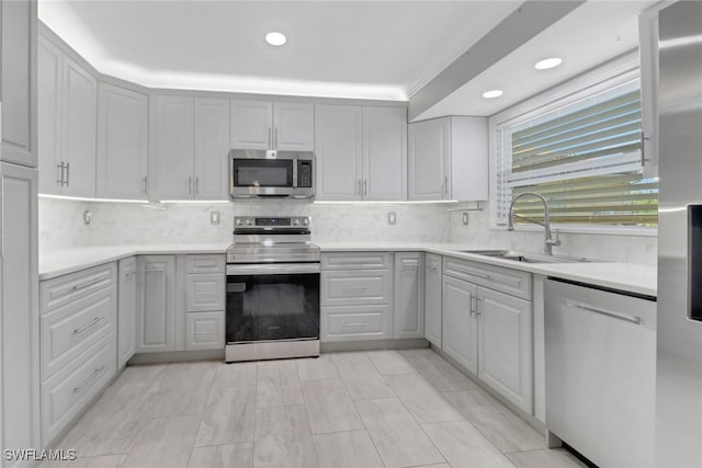 2324 Westwood Rd, North Fort Myers, FL 33917 - kitchen featuring decorative backsplash, light countertops, a sink, and appliances with stainless steel finishes