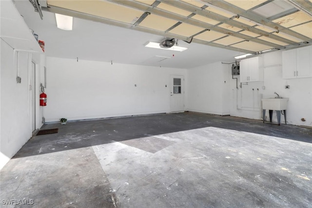 2324 Westwood Rd, North Fort Myers, FL 33917 - garage featuring a garage door opener and a sink