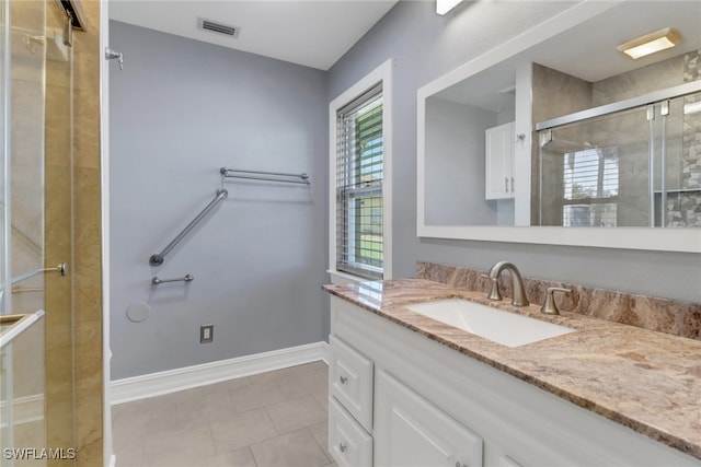2324 Westwood Rd, North Fort Myers, FL 33917 - full bathroom featuring visible vents, baseboards, tile patterned flooring, vanity, and a stall shower