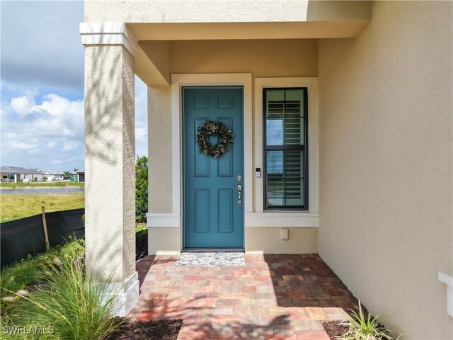 6329 Honor Way, Ave Maria, FL 34142 - view of exterior entry with stucco siding