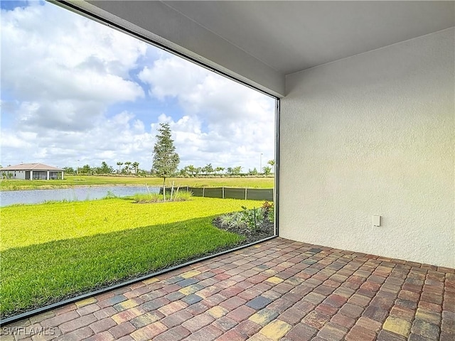 unfurnished sunroom with a water view