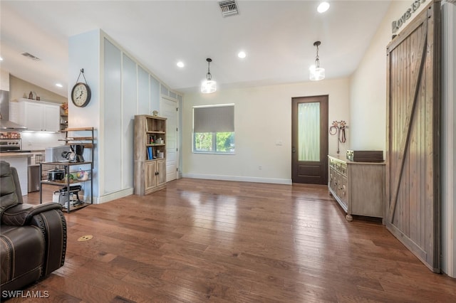 living area with baseboards, visible vents, dark wood finished floors, and vaulted ceiling