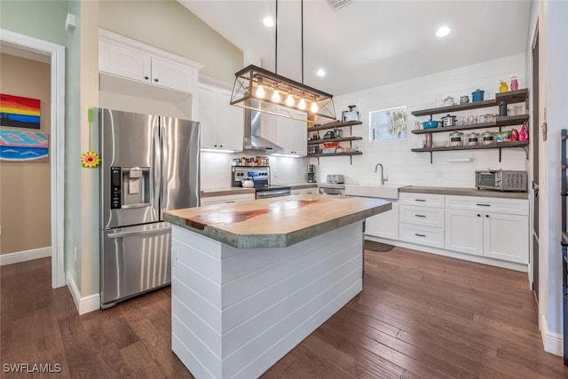 kitchen with open shelves, appliances with stainless steel finishes, a sink, backsplash, and a kitchen island