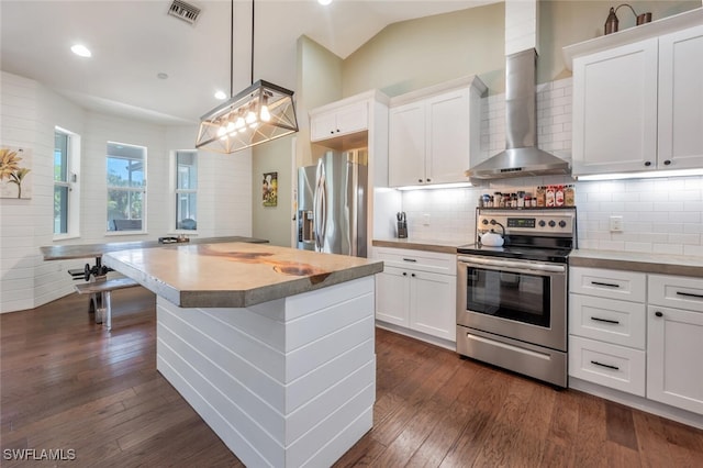 482 10th Ave NW, Naples, FL 34120 - kitchen with stainless steel appliances, wall chimney range hood, dark wood-type flooring, white cabinets, and recessed lighting