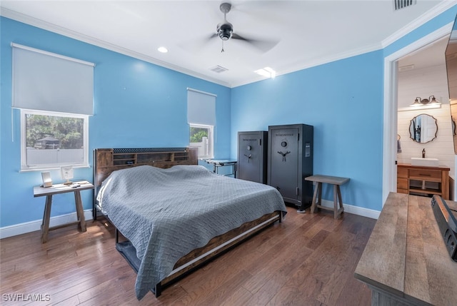 bedroom featuring crown molding, baseboards, wood finished floors, and visible vents