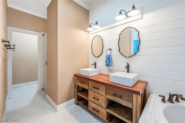 bathroom featuring double vanity, a sink, a bathtub, and ornamental molding