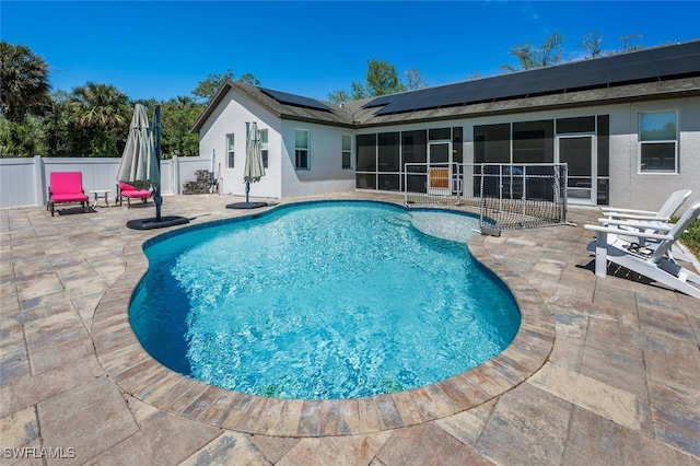 view of swimming pool featuring a fenced in pool, a fenced backyard, a sunroom, and a patio area