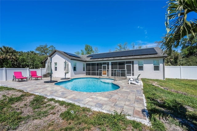 view of pool featuring a fenced backyard, a fenced in pool, a sunroom, and a patio area