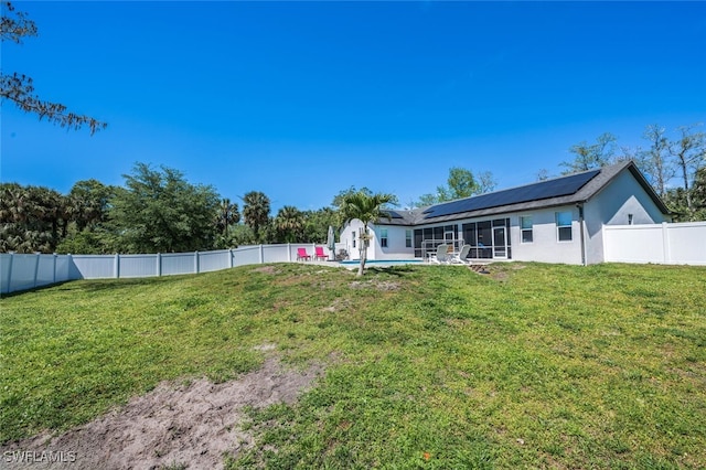 view of yard featuring a fenced backyard, a fenced in pool, and a sunroom