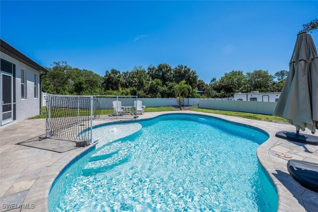view of pool featuring a fenced backyard, a fenced in pool, and a patio area