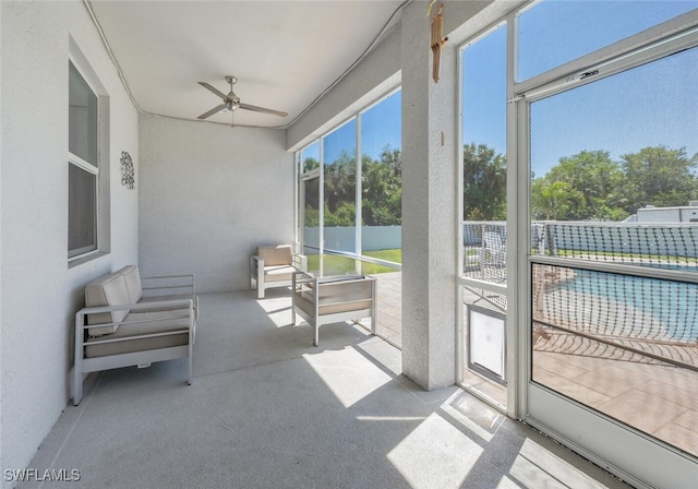 sunroom / solarium featuring ceiling fan
