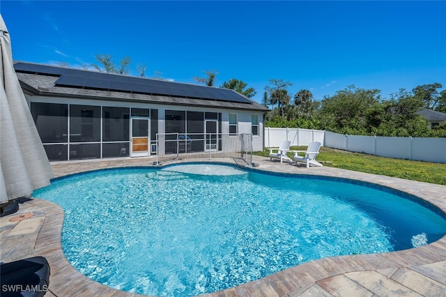 view of pool featuring a sunroom, a fenced backyard, a patio area, and a fenced in pool