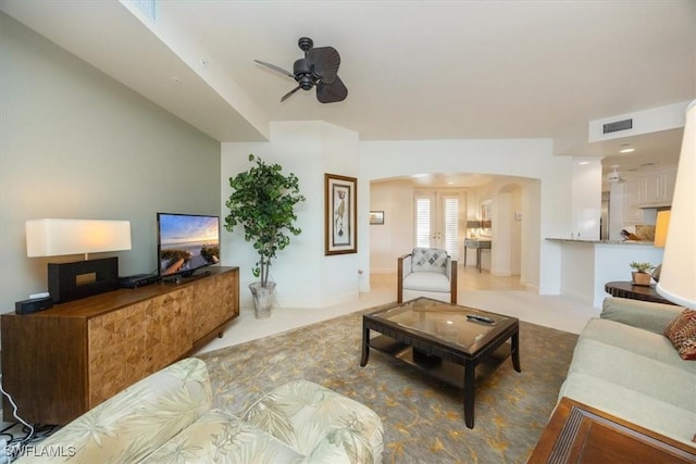730 Waterford Dr Unit 102, Naples, FL 34113 - carpeted living room with visible vents, arched walkways, and a ceiling fan