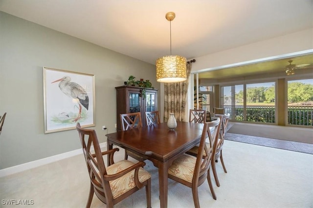 730 Waterford Dr Unit 102, Naples, FL 34113 - dining space featuring vaulted ceiling, baseboards, and light colored carpet