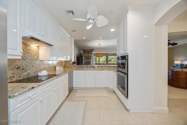 730 Waterford Dr Unit 102, Naples, FL 34113 - kitchen with arched walkways, under cabinet range hood, black electric cooktop, and a ceiling fan