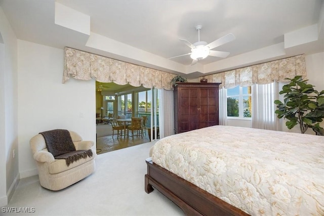 730 Waterford Dr Unit 102, Naples, FL 34113 - carpeted bedroom featuring access to outside, a tray ceiling, multiple windows, and baseboards
