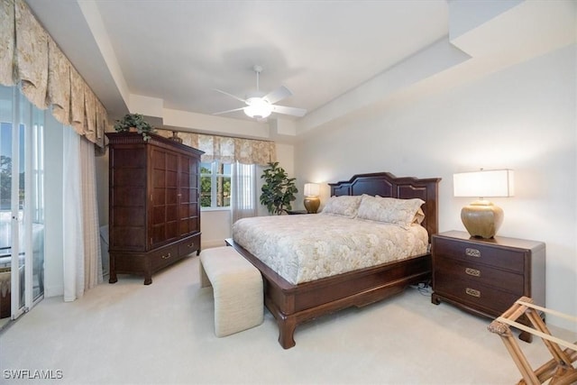 730 Waterford Dr Unit 102, Naples, FL 34113 - bedroom featuring a raised ceiling, light carpet, and ceiling fan
