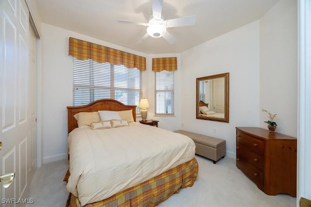 730 Waterford Dr Unit 102, Naples, FL 34113 - bedroom with light carpet, baseboards, a closet, and ceiling fan