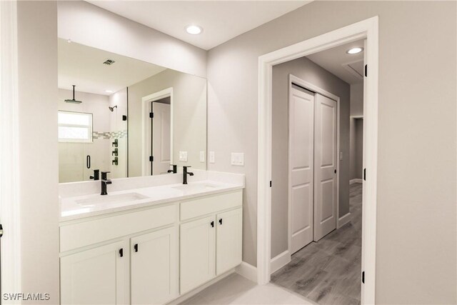 27260 Porto Nacional Dr, Punta Gorda, FL 33983 - bathroom with a shower stall, double vanity, baseboards, and recessed lighting