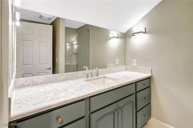 27231 Lakeway Ct, Bonita Springs, FL 34134 - bathroom with lofted ceiling, visible vents, and vanity
