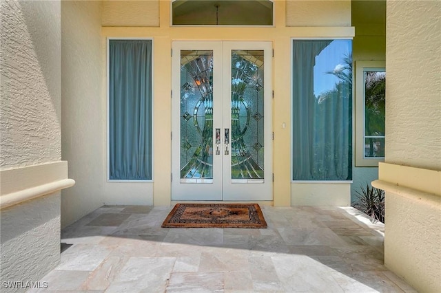 27231 Lakeway Ct, Bonita Springs, FL 34134 - view of exterior entry with french doors and stucco siding