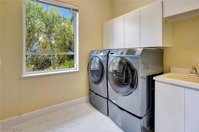 27231 Lakeway Ct, Bonita Springs, FL 34134 - washroom featuring marble finish floor, baseboards, separate washer and dryer, and cabinet space