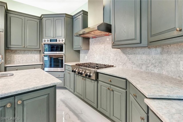 27231 Lakeway Ct, Bonita Springs, FL 34134 - kitchen with light countertops, stainless steel appliances, decorative backsplash, marble finish floor, and wall chimney range hood