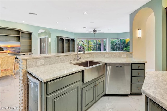 27231 Lakeway Ct, Bonita Springs, FL 34134 - kitchen with stainless steel dishwasher, a sink, arched walkways, ceiling fan, and visible vents