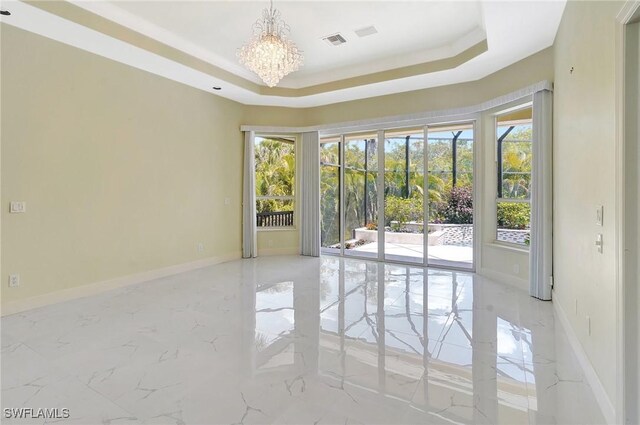 27231 Lakeway Ct, Bonita Springs, FL 34134 - empty room featuring a tray ceiling, a notable chandelier, marble finish floor, baseboards, and visible vents
